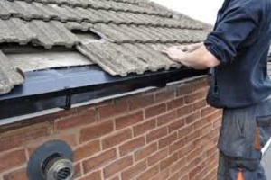 Removing the bottom rows of tiles, replacing the damage felt and fitting eave trays.