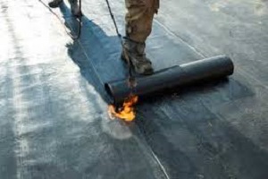 Burning on the second and middle layer when felting a flat roof nears Urmston. 