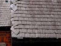 Loose slates repaired on a gable end in Stretford, Manchester.